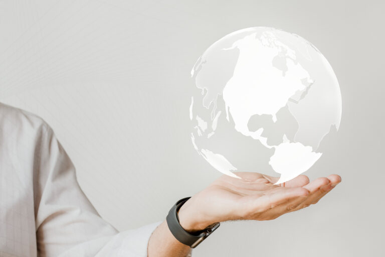businessman with a digital world in his hand